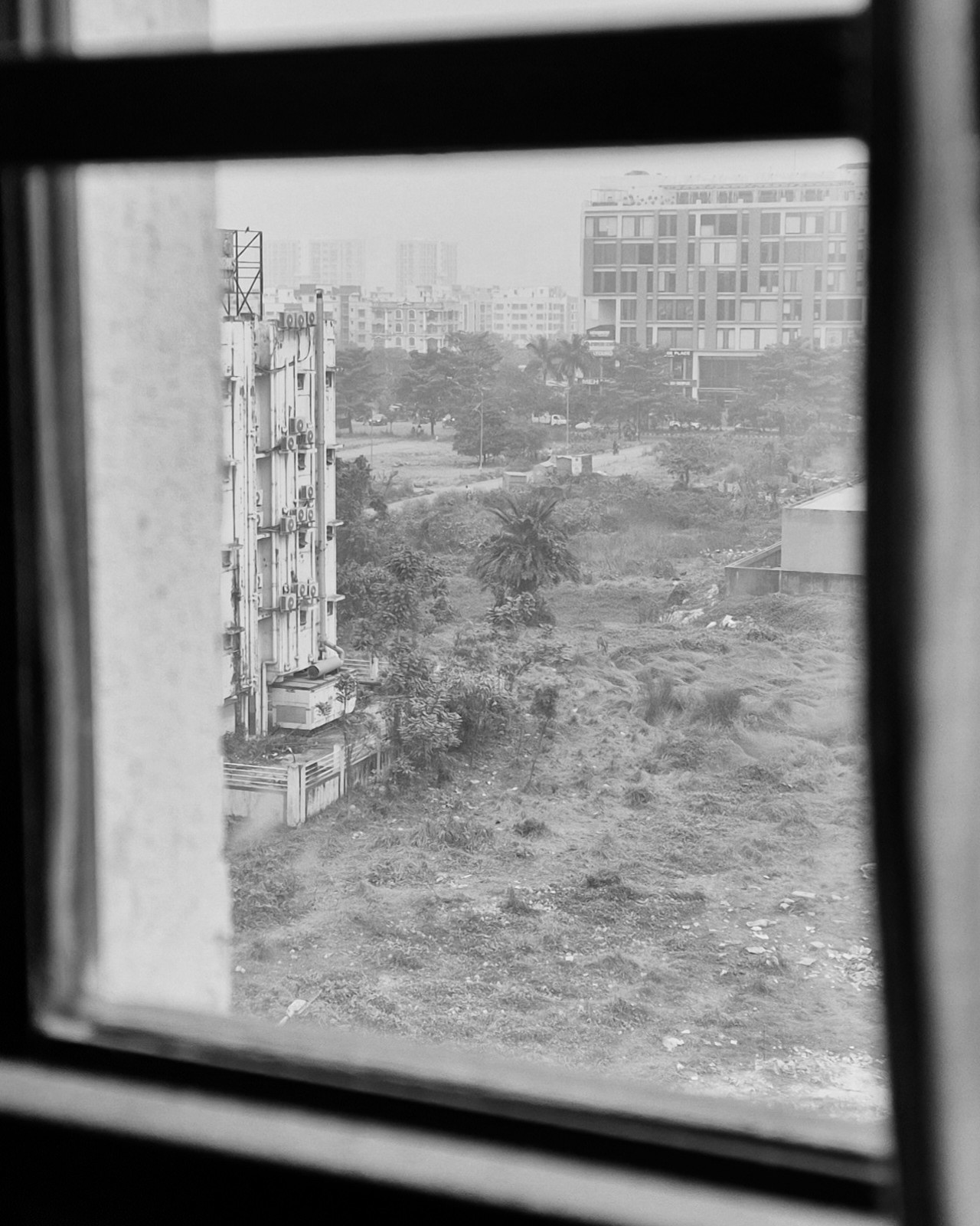 Shows a street from inside a room in a building